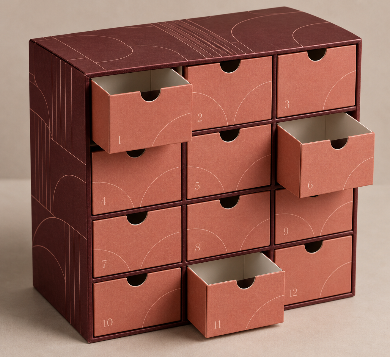 Illustrative concept of a custom 12-drawer rigid paperboard advent calendar box in burgundy and coral